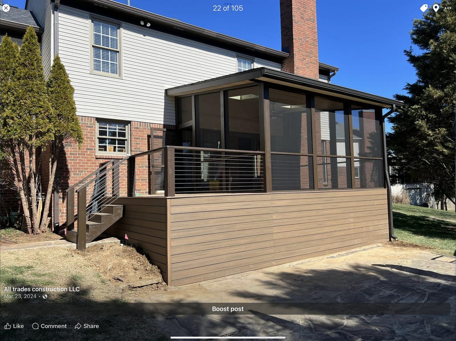 Screened porch and raised deck with cable rail on a brick house