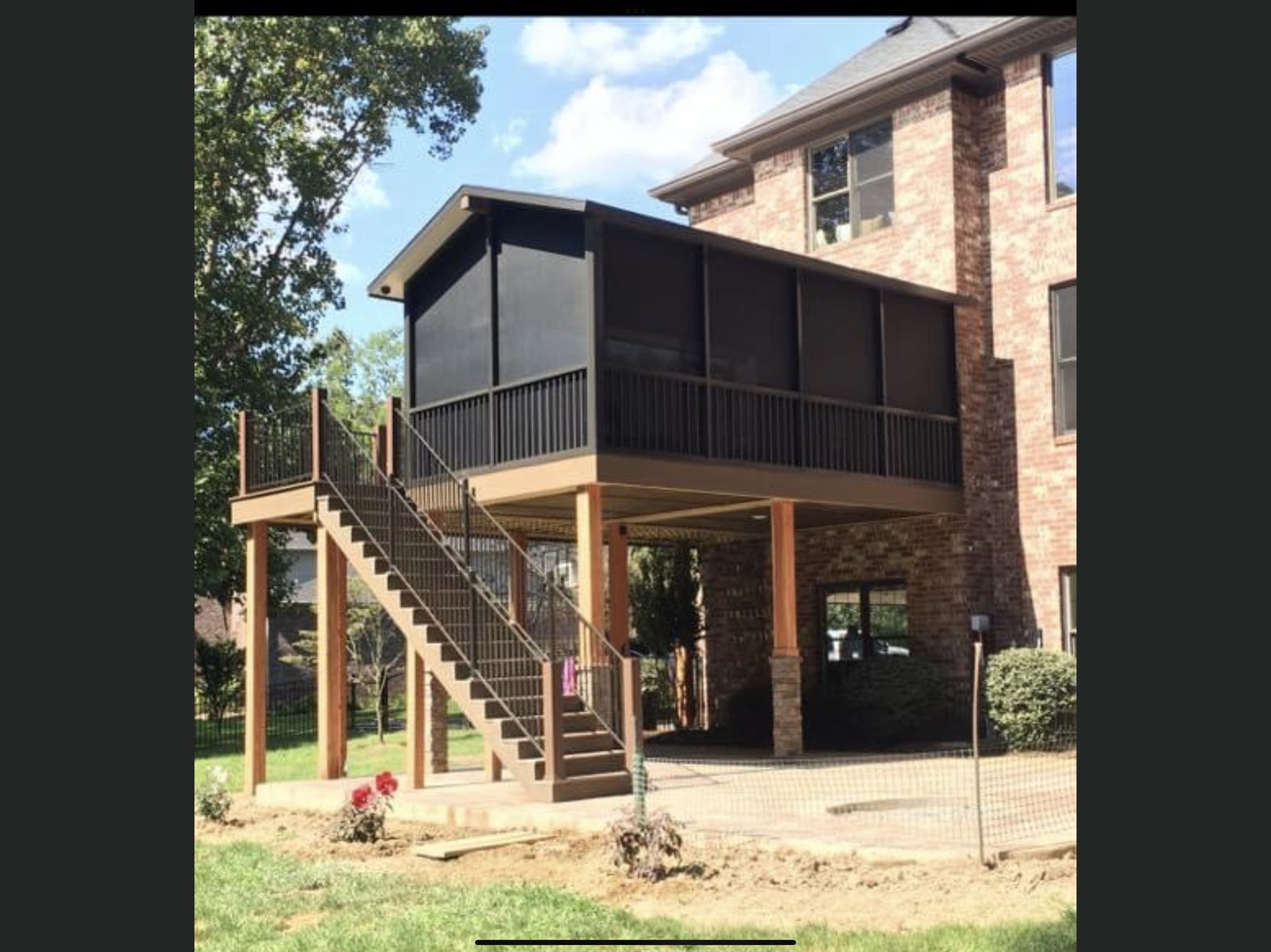 Elevated screened porch and deck on brick house with long stairs
