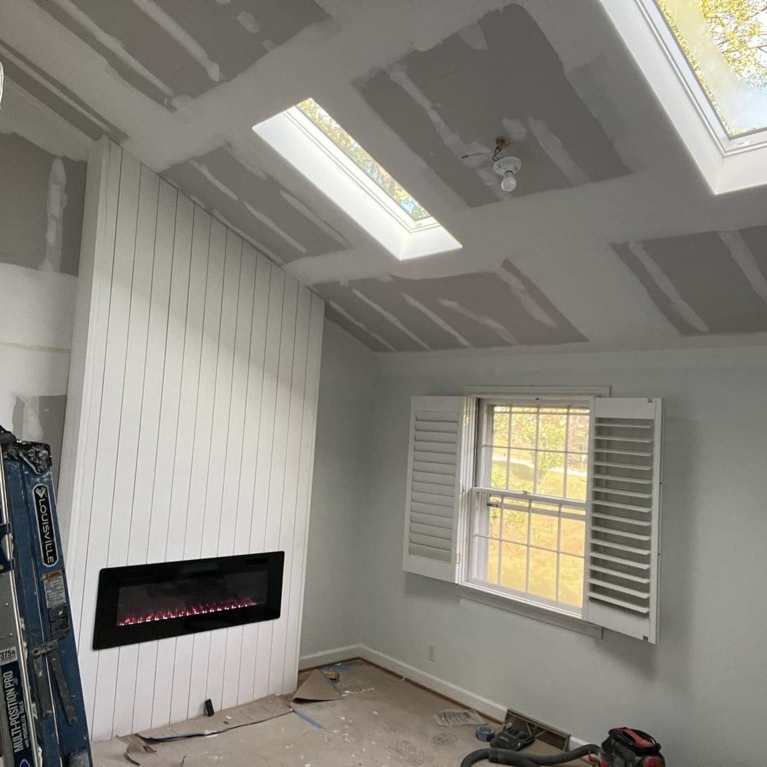 Interior remodel with shiplap fireplace wall and new skylights